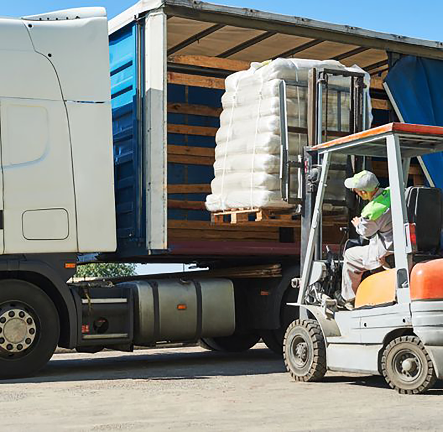 Forklift with load and lorry truck